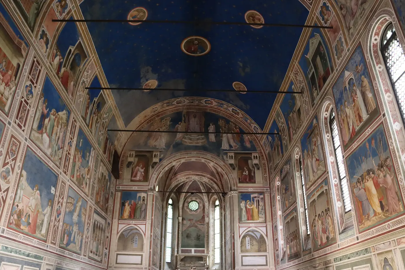 The nave of the Scrovegni Chapel looking east to the triumphal arch and the presbytery, frescoed walls on both sides