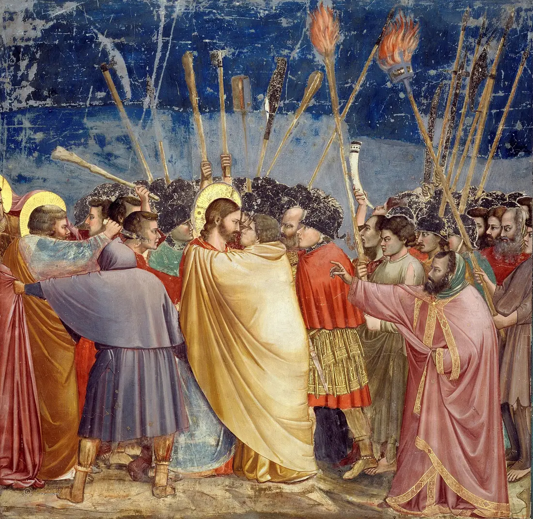 Giotto's fresco of the Kiss of Judas, a crowd raising torches and clubs around Christ and Judas face to face